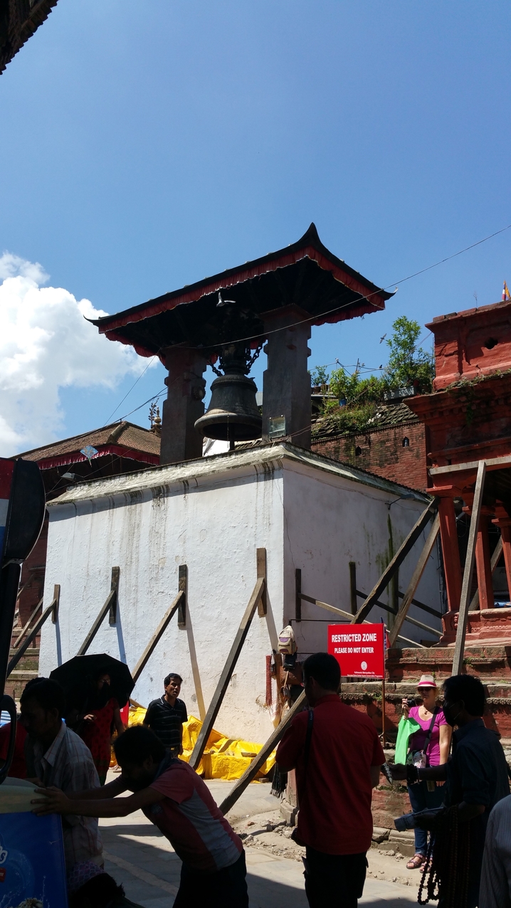 Durbar Square; Alle Gebäude und Sehenswürdigkeiten müssen abgestützt werden und sind so auch bei einem nächsten schwächeren Erdbeben stark gefährdet. So wie hier die Taleju Glocke.
